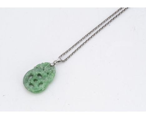 A Chinese jadeite jade pierced pendant, modelled as a bat supporting a pierced disc with a white metal bale on a silver chain