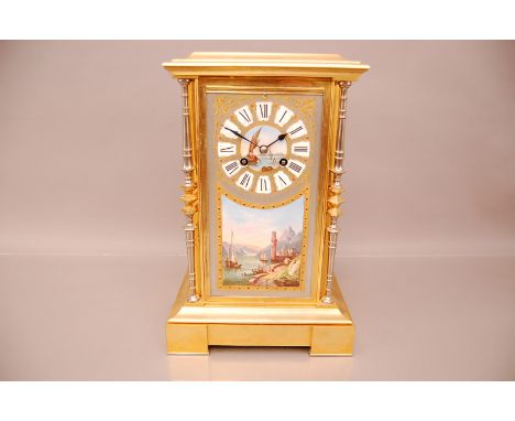 A late 19th  century French gilt and porcelain mantle clock, 35.5cm high, the rectangular with four column supports, the fron