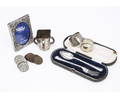 A small group of silver and other items, including a small silver tyg, a silver ingot on chain, two silver napkin rings and a