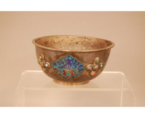 An early 20th century Chinese white metal bowl, 14.5cm diameter, with four panels of enamel design, and applied decorations
