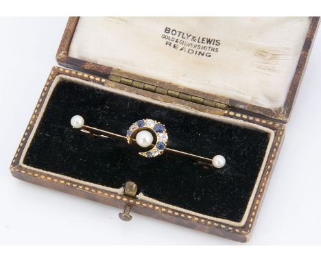 An Edwardian sapphire and diamond crescent brooch, centred with a button pearl on a gold bar, 4.2cm, diamond 0.24ct, 3.8g, ca