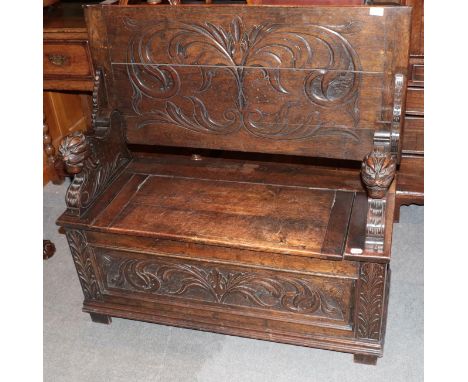 An early 20th century carved oak Monks' bench 