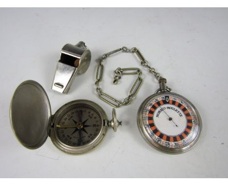 A US pocket compass together with a pocket Monaco Roulette game and whistle