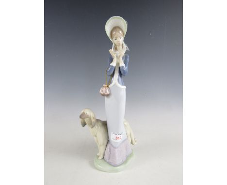 A Lladro figurine of a lady and dog, 33 cm