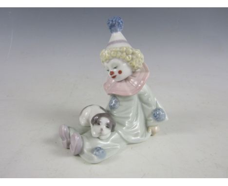 A Lladro figurine of a boy clown with a puppy