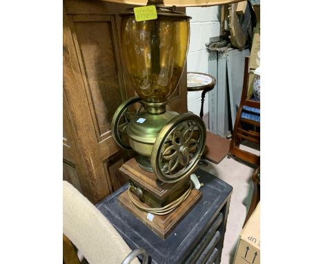 A large table lamp in the form of a vintage coffee grinder with coffee beans 