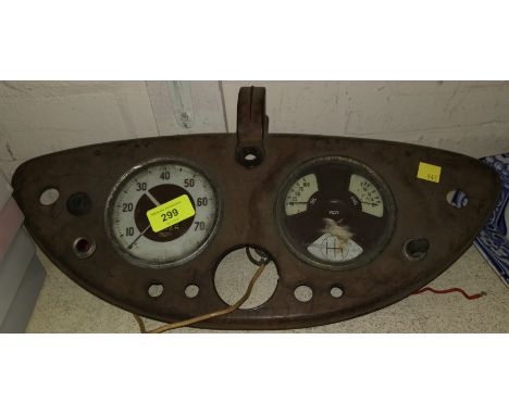 A bakelite dashboard with 2 dials from a vintage Morris car 