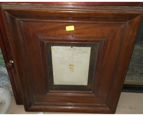 A vintage polished wood notice board with locking frame, an Underwood typewriter 