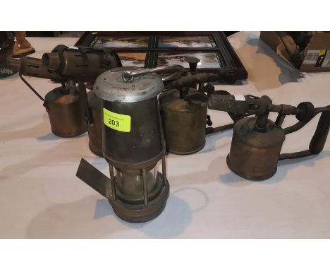 A WOLF miners lamp and 4 brass blowlamps 