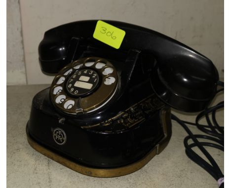 A vintage Japanned metal and brass Bell rotary telephone with Bakelite receiver 