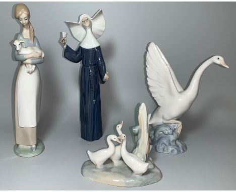 A Lladro group - Girl with Lamb (ear a.f.), another of a Nun, a NAO swan and a group of geese 