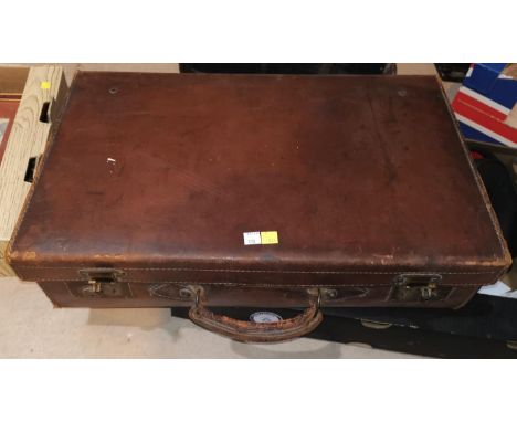 An old leather suitcase &amp; a selection of vintage unused suitcase labels 