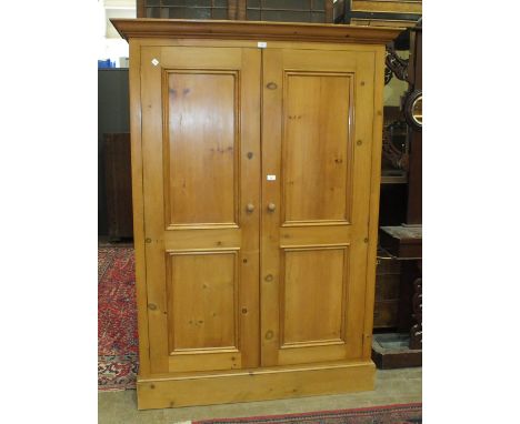 A modern pine two-door wardrobe, 131cm wide, 184cm high.