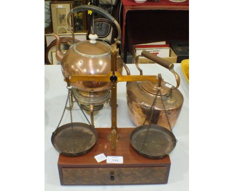 A set of travelling metal beam scales in stained wood box fitted with a drawer and weights, 33cm high overall, a copper spiri