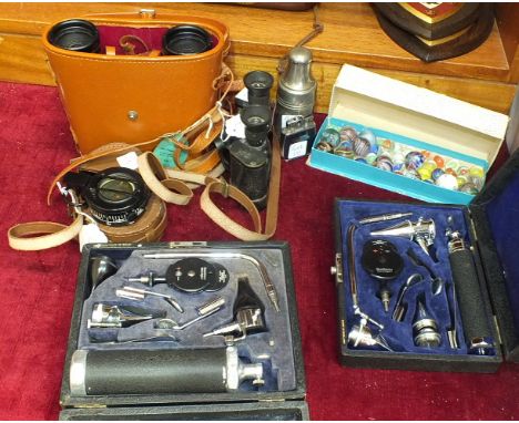 A black lacquered prismatic compass by T G & Co. Ltd, London, no.B6020 MkIII, 1939, in leather case, a pair of Vesper Superfi