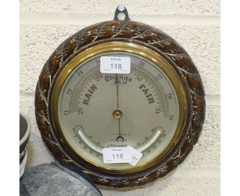 T L Ainsley Ltd, South Shields, a circular aneroid barometer/thermometer within a wooden rope-twist frame, 23cm diameter over