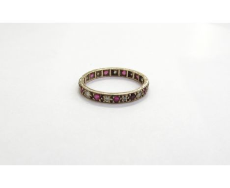 A 9ct gold ruby and diamond eternity ring. Size L, 1.1g