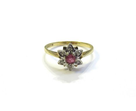 An 18ct gold ruby and diamond cluster/star ring. Size Q/R, 2.8g
