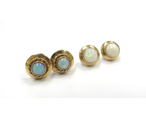 A pair of opal stud earrings stamped 9ct and another pair of opal stud earrings