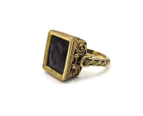 An unmarked gold ring with an intaglio depicting a bust of a Roman soldier, ornate scroll frame. Size P,  7.2g