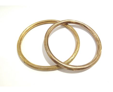 A 9ct rose gold slave bangle, 10g and another gold plated example