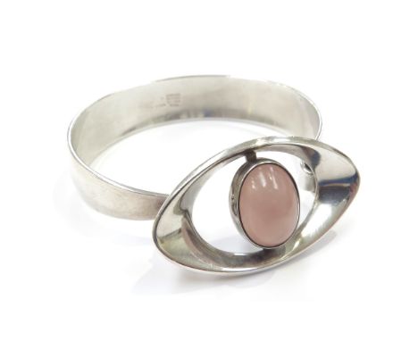 A Danish silver modernistic bangle by Niels Erik From with a rose quartz to an elliptical shape front