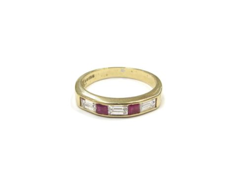 An 18ct gold diamond and ruby five stone ring, three baguette cut diamonds spaced by square rubies in channel setting. Size P