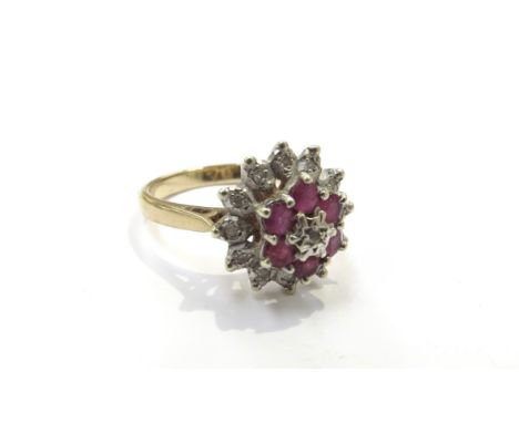 A 9ct gold diamond and ruby floral cluster ring. Size O, 3.3g