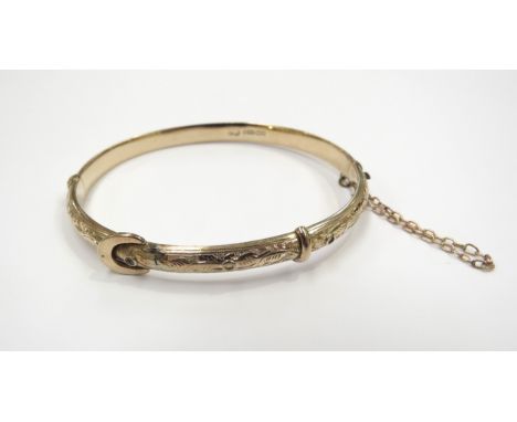 A 9ct gold hinged bangle as a buckle, seed pearls missing, 8.6g