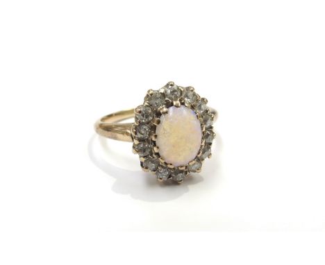 An opal and diamond cluster ring, shank stamped 14k. Size P, 3.8g