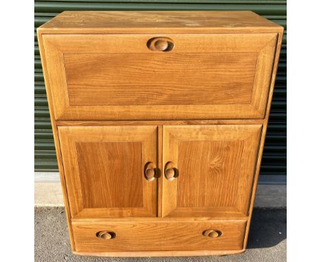 Ercol light/natural finish drinks cabinet, model 469, hinged front above cupboard and a drawer, on rollerball castors, H110cm