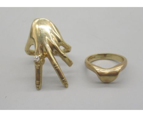 Unusual 9ct yellow gold hand ring, the ring finger set with clear stone, size T, and a 9ct yellow gold shaped band ring, size