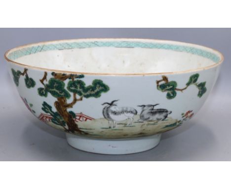 Chinese porcelain famille rose bowl, enamel decoration with two goats and a fir tree in a fenced garden, diaper border to inn