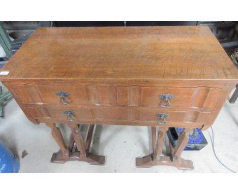 Cotswold School style oak sideboard, two short and three long drawers with cast metal handles, on faceted tapered supports wi
