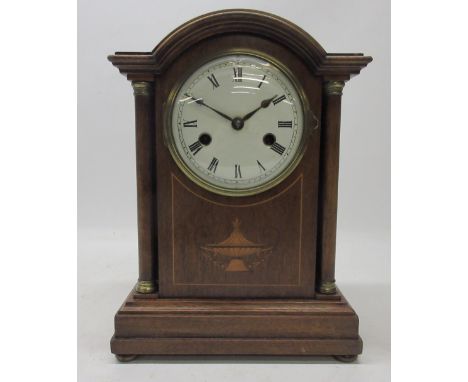 H.A.C. mahogany mantle clock, inlaid case with fully turned columns with brass capitals, brass bezel enclosing 4 1/2" white e
