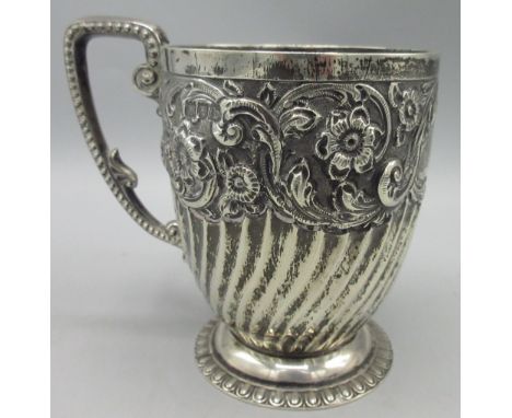 Victorian silver Christening mug, on a gadrooned circular foot, lower body reeded and upper decorated in a floral repousse by