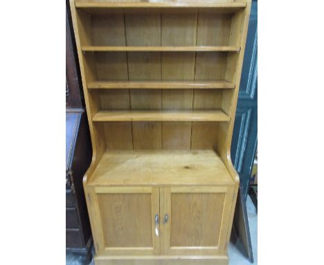 20th century Gott of Pickering light oak side cabinet, three adjustable shelves above two doors, on skirted base, W92cm D46cm