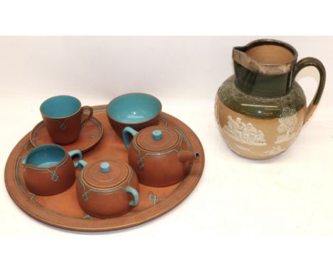 Doulton Lambeth water jug with silver rim, H19cm; and a Watcombe Pottery terracotta tea service on circular tray, D34.5cmShip