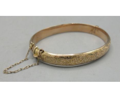 9ct yellow gold hinged bangle with ornate decoration to half, stamped 375, 8.27gShipping £23.00 plus vat (UK Only)