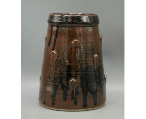 Jeremy Leach tapered cylindrical vase, with applied studs in a brown glaze, H17.5cmShipping £38.00 plus vat (UK Only)