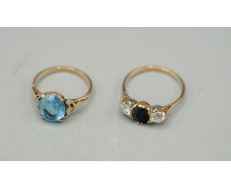 9ct yellow gold ring set with oval cut blue topaz, stamped 9ct, size K, and a 9ct yellow gold ring set with central sapphire 