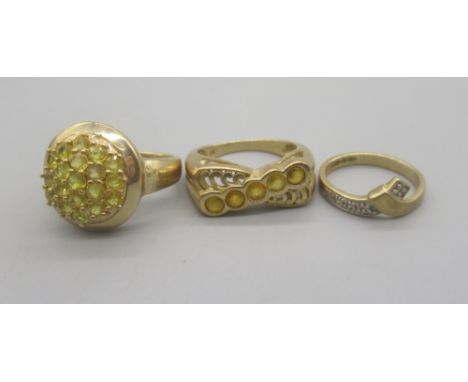9ct yellow gold cluster ring set with yellow stones, size N, a 9ct yellow gold ring set with row of five yellow sapphires, si