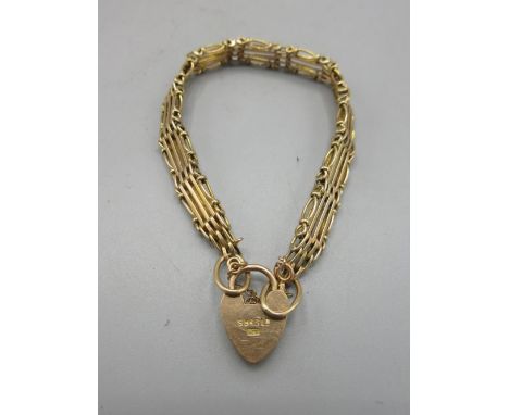 9ct yellow gold four gate heart padlock bracelet, safety chain AF, stamped 9ct, L18.5cm, 12.1gShipping £23.00 plus vat (UK On