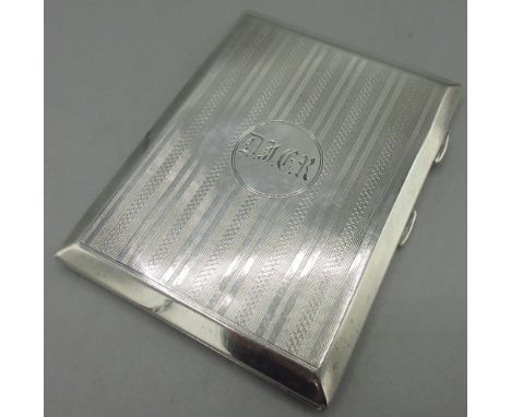 George V silver cigarette case with monogrammed cartouche, engine turned pattern to front & back, gilt interior by S Blancken
