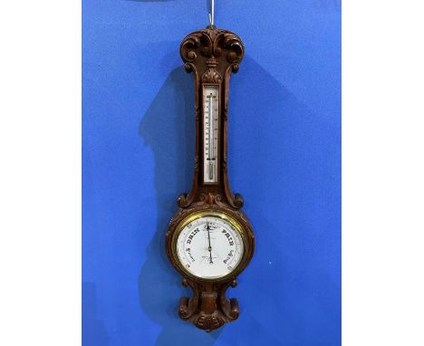 C20th carved oak cased Negretti & Zambra Aneroid barometer and thermometer, No.27238, H91cmShipping POA https://www.bradleys.