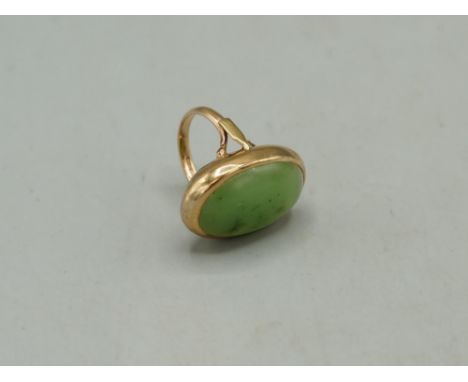 9ct yellow gold cocktail ring set with cabochon jade, stamped 375, size N1/2, 10.69gShipping £20.00 plus vat (UK Only)