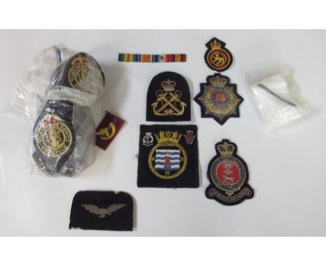 Large collection of military cap badges, buttons, pins, and patches. Including a Royal Army Service Corps patch, The Queen's 