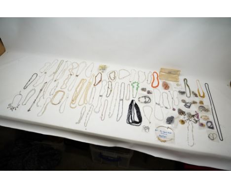 Collection of costume jewellery to include large quantity of beaded necklaces, Royal Worcester brooches and pins, etcShipping