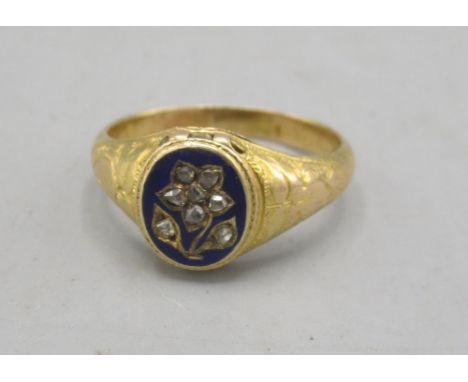 Georgian yellow metal mourning ring, the central oval panel with forget-me-not flower set with old cut diamonds on blue ename