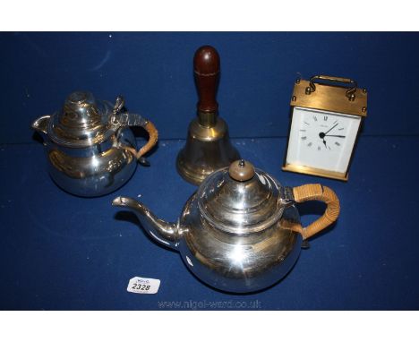 A silver plated Teapot and water Jug with coin in the lid, brass bell and Seixo Carriage Clock.